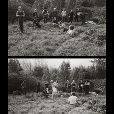Two black-and-white photographs of a large group posed and playing in a grassy, shrub-lined field, several holding cameras; a young girl throwing a ball up in the air is the focus of the lower panel.