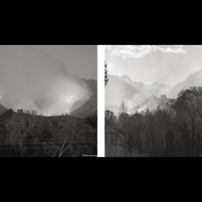 Two black-and-white photographs of wildfire haze filling a mountain valley, glowing fire visible through smoke on the left and a smoky, tree-lined ridge on the right.