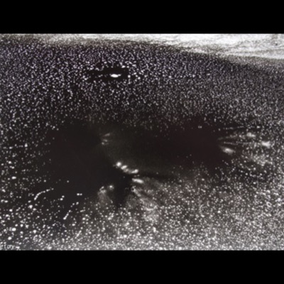 Peter de Lory, "Ice Galaxy," Weston, Massachusetts, 1973 — a black-and-white photograph of a dark, star-flecked ice surface, tiny bright points scattered like a night sky.