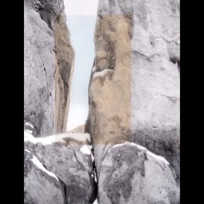 Peter de Lory, "Garden of the Gods," Colorado, 1973, hand-colored with photographic oils — a narrow rock crevice opens onto pale sandstone formations and blue sky, the center panel tinted warm ochre against the surrounding black-and-white rock.