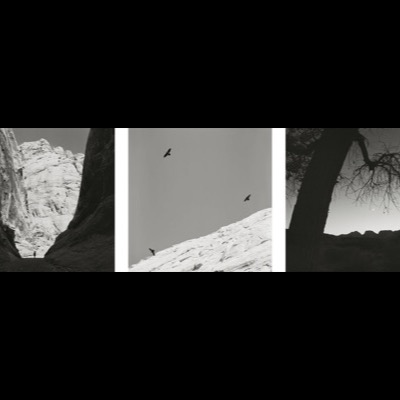 Peter de Lory, "Spirit of Place", 1992 -- a black-and-white triptych: star trails over a desert mountain, cracked playa mud tracing a sliding rock’s path, and a stone cliff-dwelling ruin (plate 42 of 54)