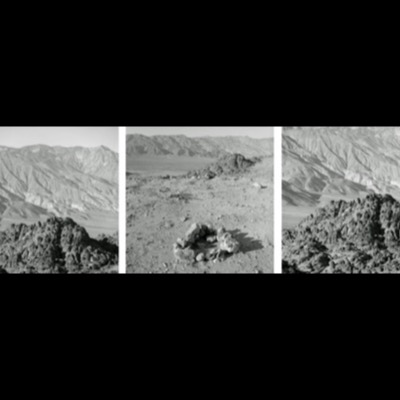 Three black-and-white photographs of layered desert mountain ranges, a small rock cairn built on open desert ground, and a rugged mountainside of jagged boulders.