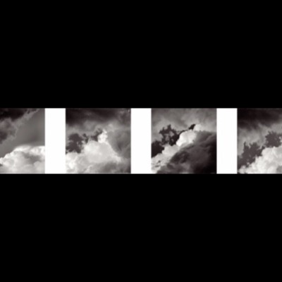 Four black-and-white photographs of towering cumulus clouds lit from behind, arranged side by side, dark storm shadow contrasting with brilliant white cloud tops against the sky.